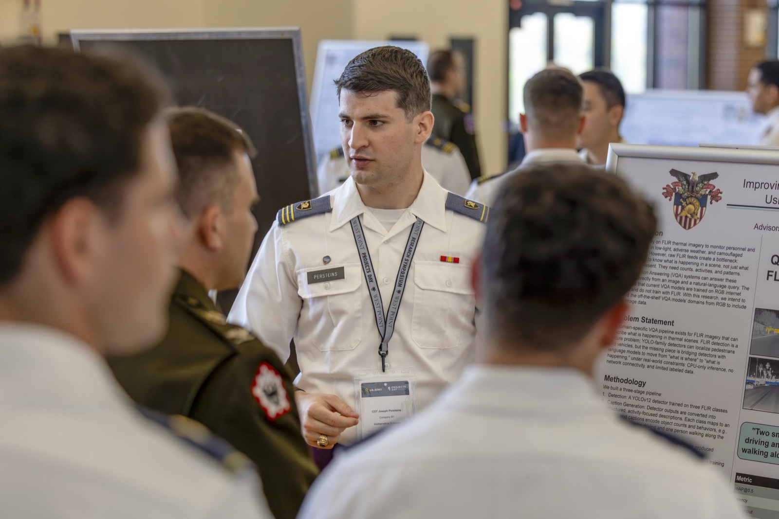 Joseph Persteins presenting a research poster on infrared image captioning.